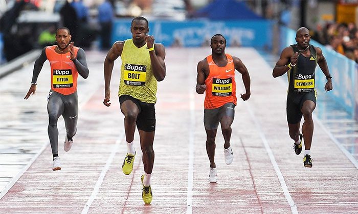 Usain Bolt (in yellow) holding the Olympic and world record in the 100-meter dash