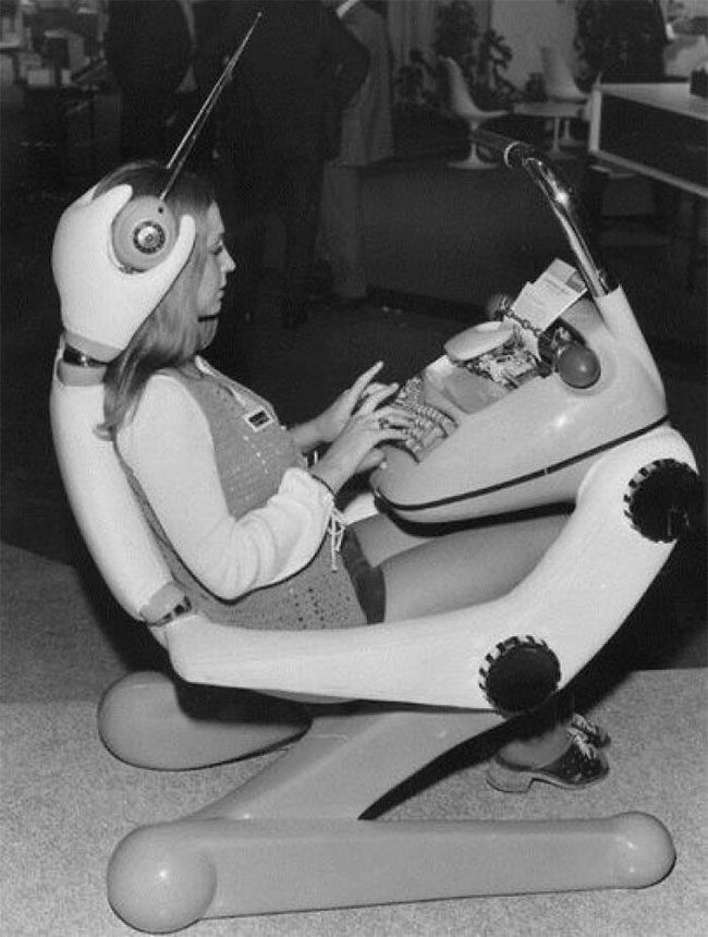 A woman at a typewriter with headphones and a lamp in Paris in 1972.