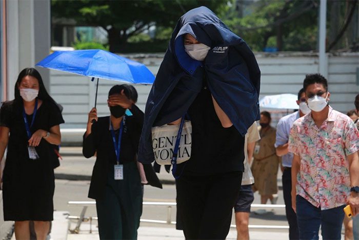 Residents of Bangkok, Thailand walking under the scorching sun on April 15.