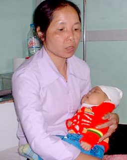 Baby Bui Thi Thu, 3 months old in her mother's arms