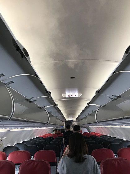 The white mist emitted from the airplane ceiling is to adjust air pressure.