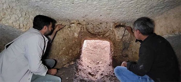 The entrance of the ancient tomb has been narrowed by earth and stone