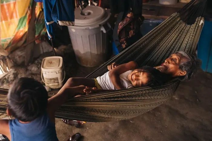 Children playing with their grandmother in a 12-member household on Gardi Sugdub Island.