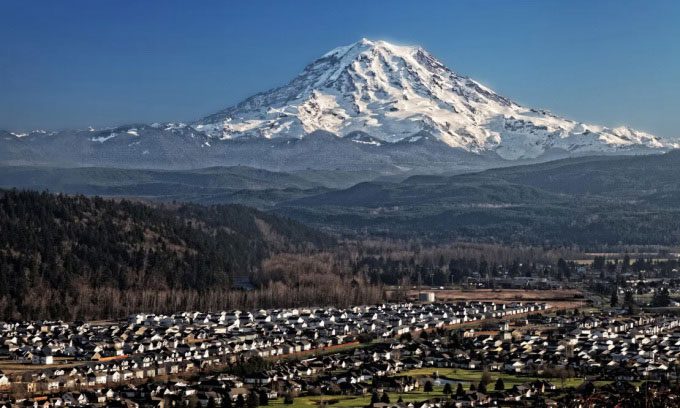 Snow-covered Mount Rainier stands majestically near Orting, Washington.