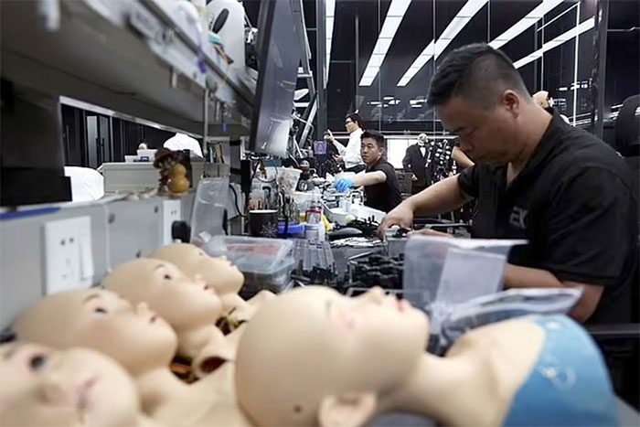 Images of employees assembling humanoid robots at the Ex-Robots factory in Dalian