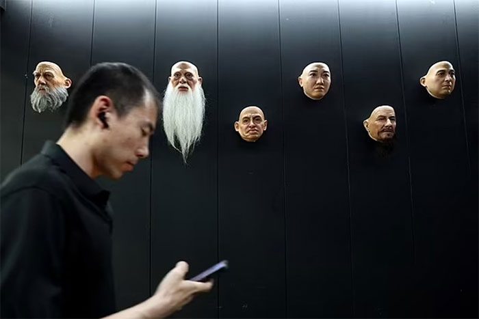 An employee working near the display of humanoid robot parts