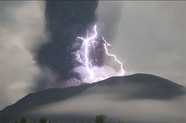 Lightning appears during the storm when Mount Ibu erupts on May 18