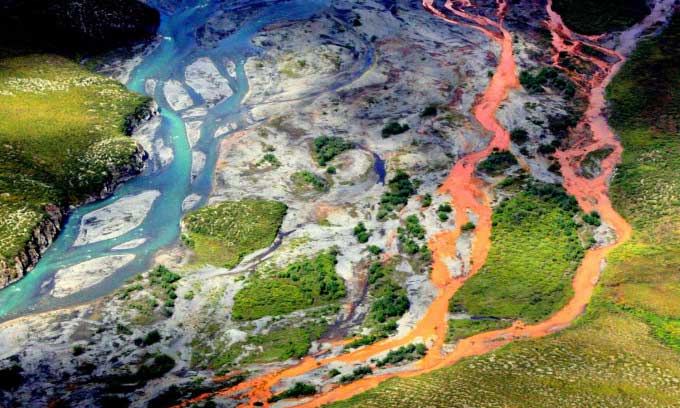 Rust-colored Kutuk River in Gates of the Arctic National Park, Alaska, viewed from above.