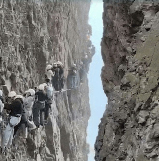 Tourists stuck on a vertical cliff at Mount Yan Dang, China.