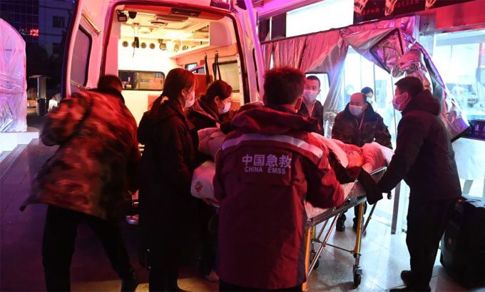 Rescue workers transport victims to the hospital after the earthquake in Gansu Province, China.