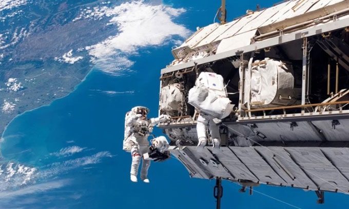 Astronauts performing a spacewalk outside the ISS.