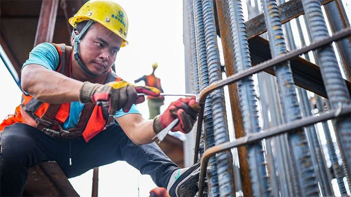 Workers at the construction site of the Huajiang Grand Canyon Bridge