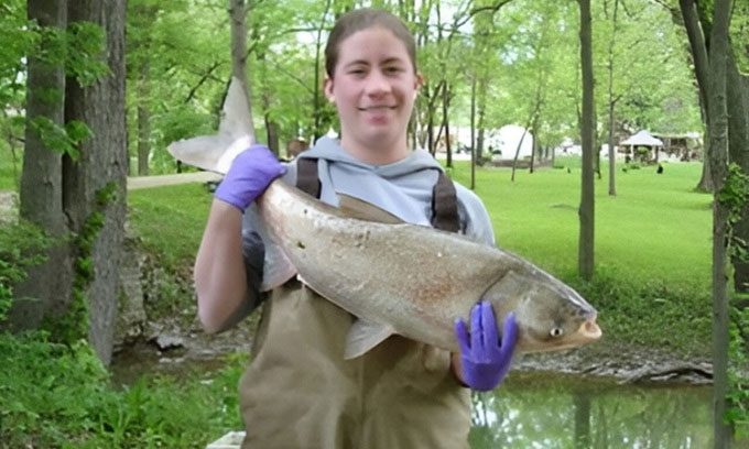 Alison Coulter with invasive white carp.