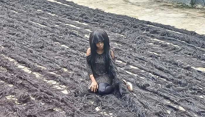 Helen Williams and her handcrafted wig measuring 351.28 meters.