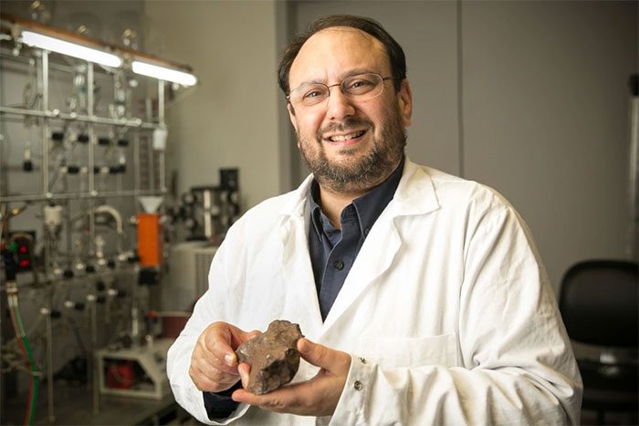 Dr. Jason Dworkin holding a geological sample.