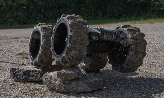 Onyx robot overcoming obstacles on land.