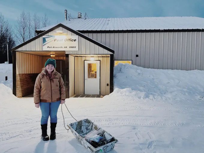 Salina Alsworth standing in front of her home.