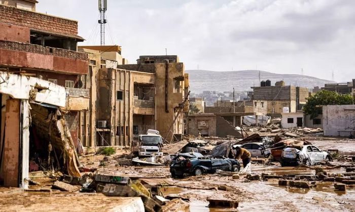 Destroyed vehicles and damaged buildings in the city of Derna, east of Benghazi.