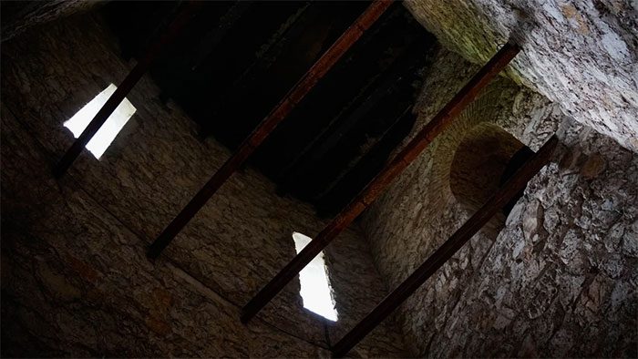 Looking Up at the Time-Stained Windows on the Stone Wall.