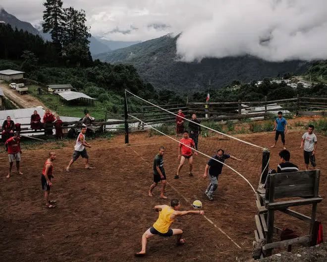 Monks playing volleyball with local police.