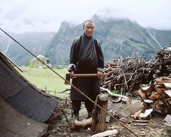 A man named Tshering preparing firewood near the Masangang glacier.