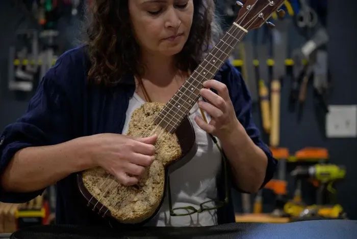 Rachel Rosenkrantz playing an ukulele made from mushroom fibers.