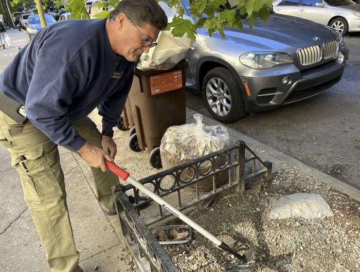 Deodato injecting poison into a rat burrow.