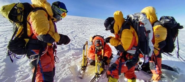 Expedition members measuring snow thickness on the summit of Cho Oyu on October 1.