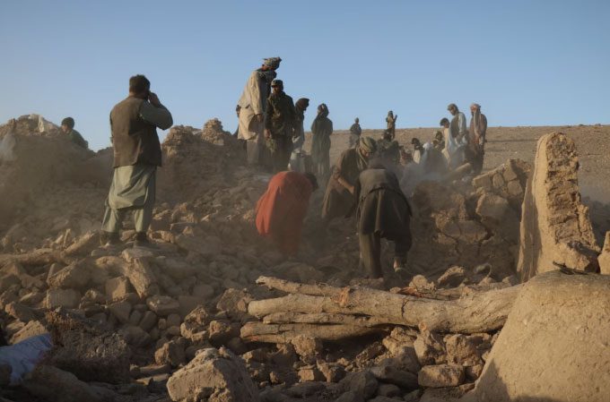Afghan residents search through rubble for survivors on the outskirts of Herat