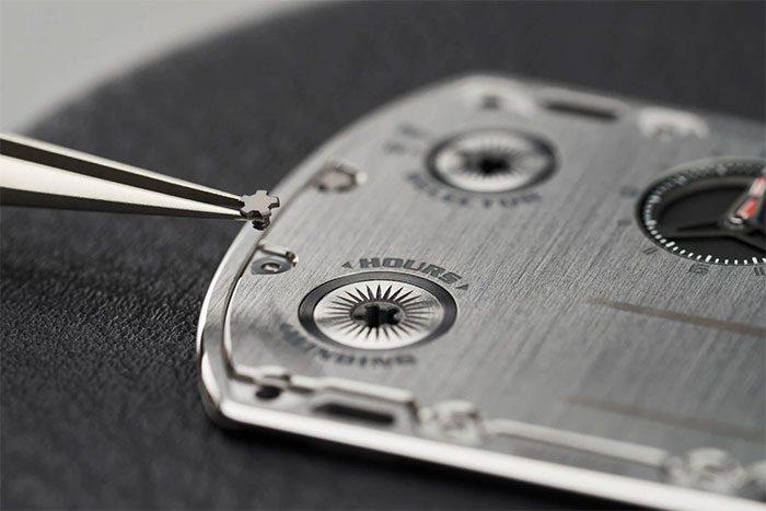 The two crowns are positioned on the watch dial.
