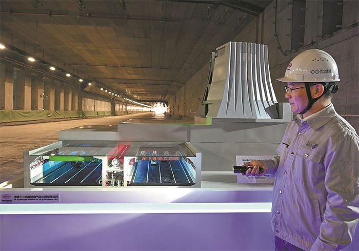 Workers demonstrate the structure of the 6.8-kilometer underwater tunnel.