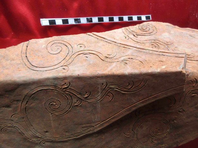 A piece of the ancient temple roof's corner found and preserved at the temple.