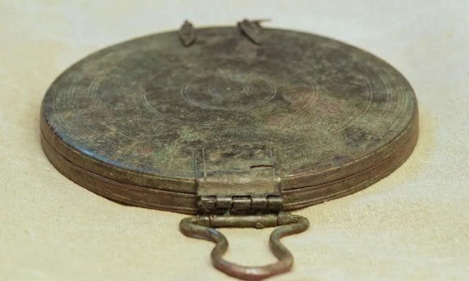 Bronze box mirror buried with the woman's remains.