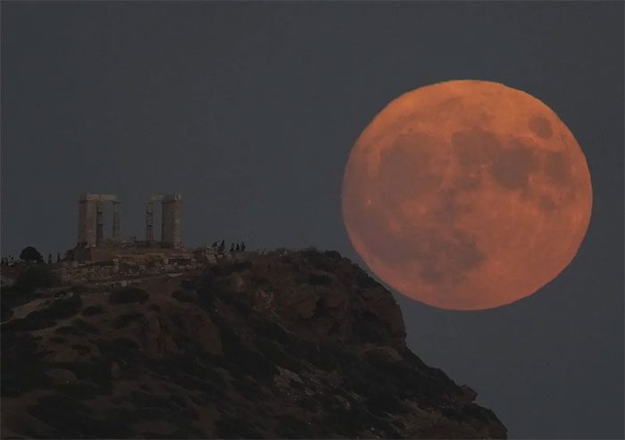 The Supermoon behind the ancient Temple of Poseidon at Cape Sounion