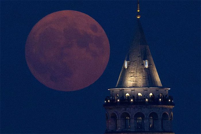 The Moon rising over Galata Tower, Istanbul, Turkey