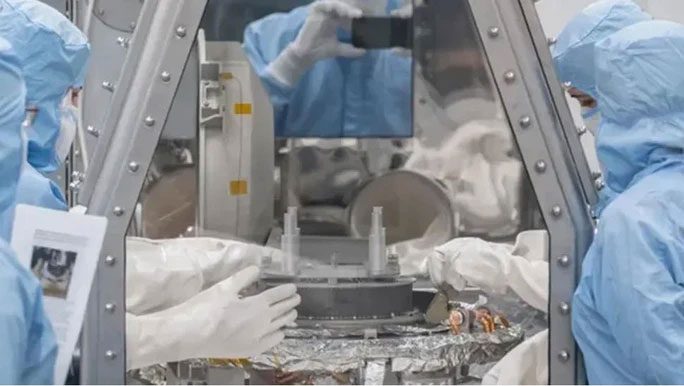 The sample collection box from asteroid Bennu being processed by NASA scientists