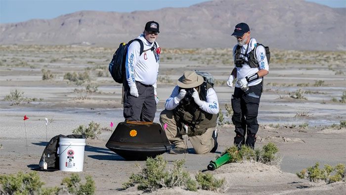NASA personnel approaching to recover the sample capsule.