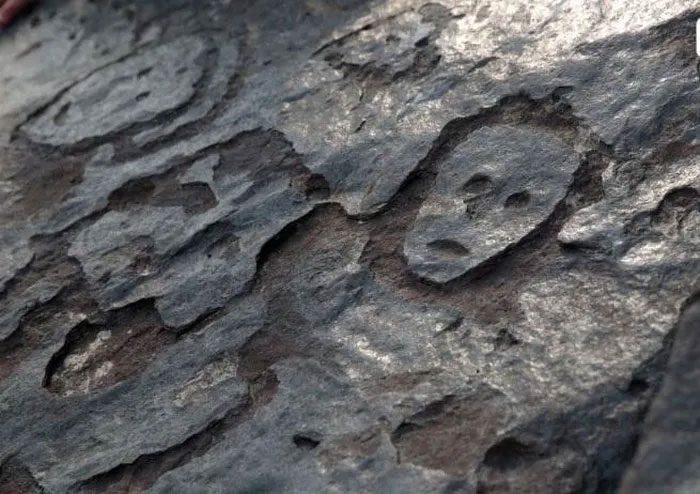Human faces on rock