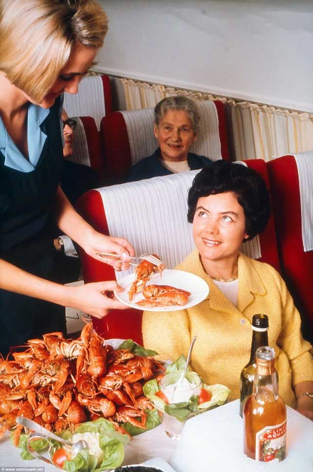 A passenger being served fresh Norwegian lobster