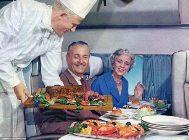 A couple choosing between meat or lobster on their plate in the 1950s