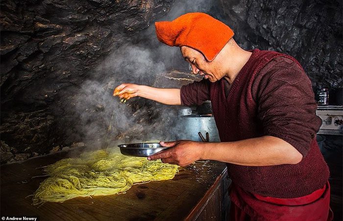A monk at Phugtal Monastery preparing a noodle feast for the celebration.