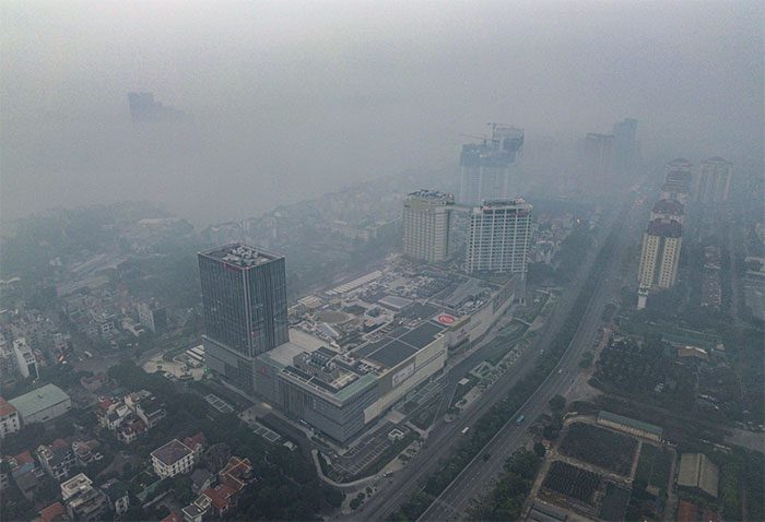 Tall buildings in Hanoi disappear in the fog and fine dust