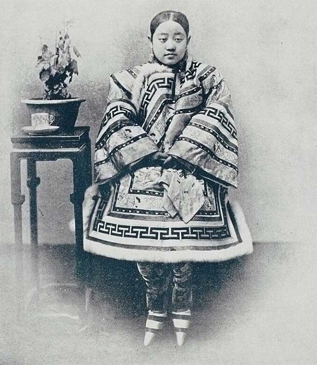 A Han woman with bound feet in winter clothing.
