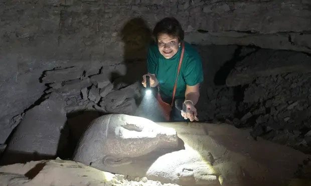 Archaeologist Ola El Aguizy examining the sarcophagus of Ptah-em-wia