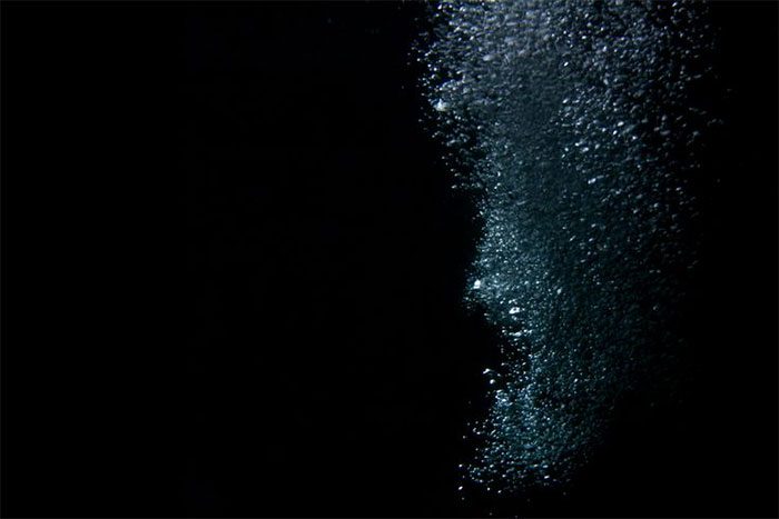 Methane gas bubbling beneath shallow waters of the Baltic Sea.