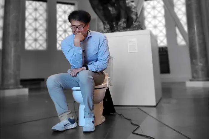 Researcher Seung-min Park with the toilet that won the Ig Nobel Prize 2023
