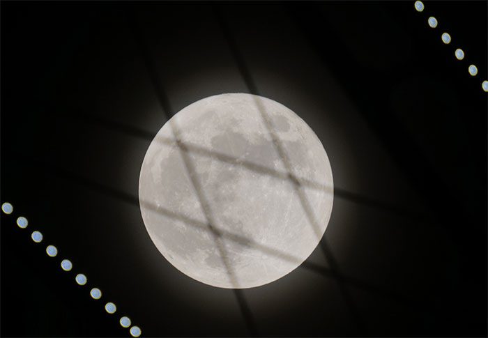 The supermoon rises behind the cable-stayed Bai Chay Bridge (Quang Ninh).