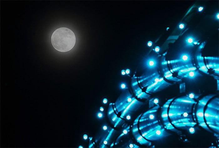 The full moon next to the Dragon Bridge in Da Nang at 8 PM.