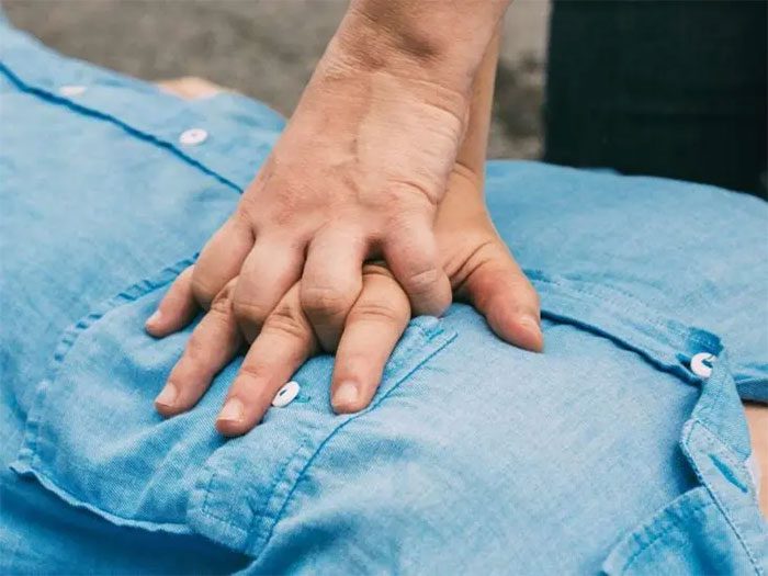 Administering CPR to a smoke inhalation victim.