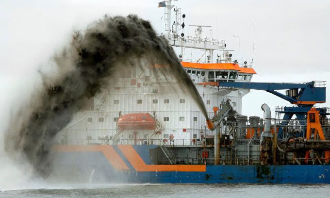 A dredging boat spraying sand in the Netherlands.